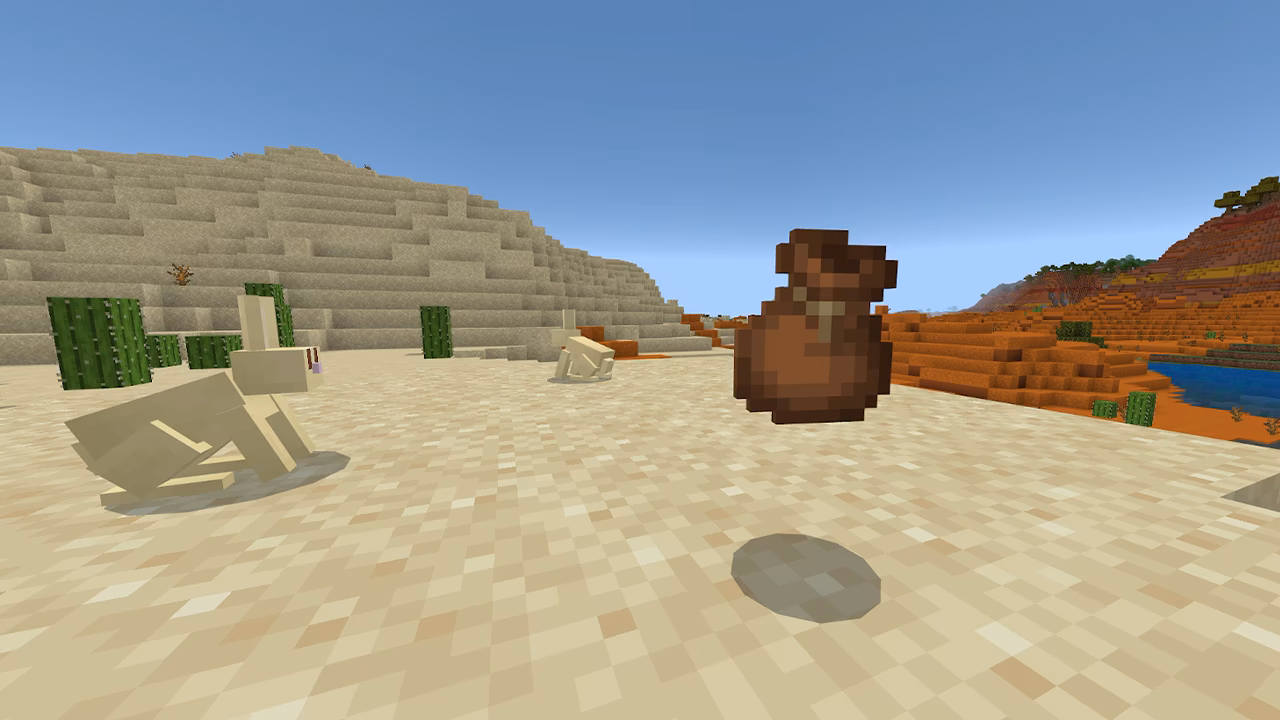 Desert biome in Minecraft with rabbits, cacti, and a bundle item.